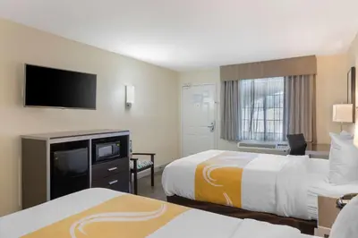 a hotel room with two beds and a flat screen tv at Quality Inn & Suites Camarillo-Oxnard in Camarillo