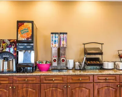 a kitchen counter with a counter top with a counter top at Rodeway Inn & Suites Corona in Corona