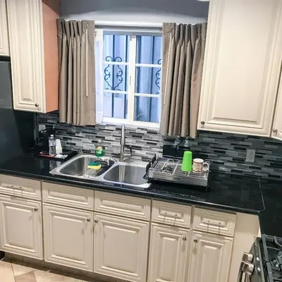 a kitchen with a sink and a window at Viking Motel-Ventura in Ventura