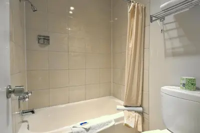 a bathroom with a bath tub and a toilet at Motel 6-Claremont, CA in Claremont