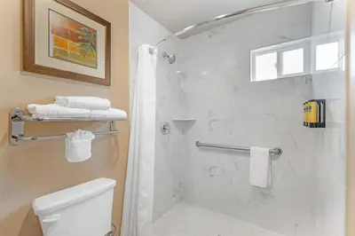 a bathroom with a shower and a toilet at Best Western Plus Pavilions in Anaheim