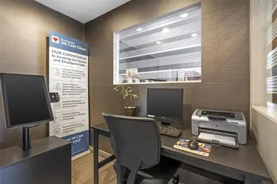 an office with a desk with a computer and a printer at Best Western Plus Pavilions in Anaheim
