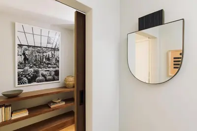 a mirror hangs on a wall in a hallway at Silver Lake Pool & Inn in Los Angeles