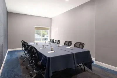 a conference room with a long table with chairs at La Quinta by Wyndham Bakersfield North in Bakersfield