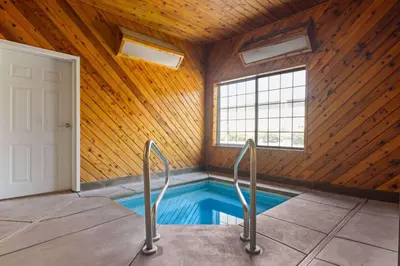 a swimming pool in a room with a wooden ceiling at La Quinta by Wyndham Bakersfield North in Bakersfield