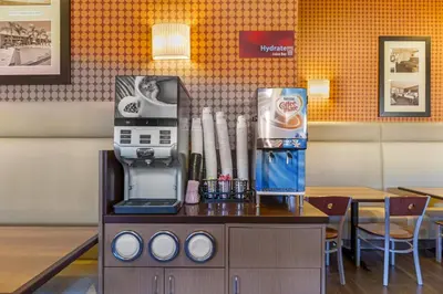 a coffee machine on a table in a restaurant at Best Western Plus Stovall's Inn in Anaheim