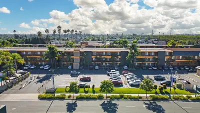 an aerial view of a hotel with a parking lot at Best Western Plus Stovall's Inn in Anaheim