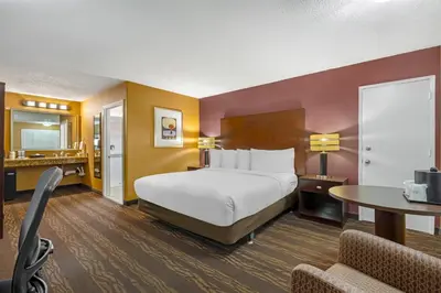 a hotel room with a bed and a table at Best Western Plus Stovall's Inn in Anaheim