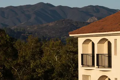 a building with a balcony and mountains in the background at Hyatt Regency Westlake in Westlake Village