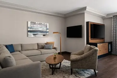 a living room with a couch and a table and a tv at Hyatt Regency Westlake in Westlake Village