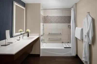 a white bathroom with a tub and a sink at Hyatt Regency Westlake in Westlake Village