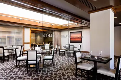 a dining room with tables and chairs and a restaurant at Hyatt Regency Westlake in Westlake Village