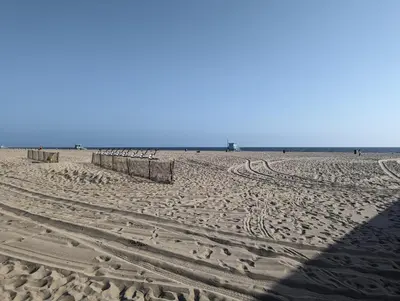 a sandy beach with footprints in the sand at 2Bedroom with Den and 2BA 4 Blocks to Santa Monica Beach in Los Angeles