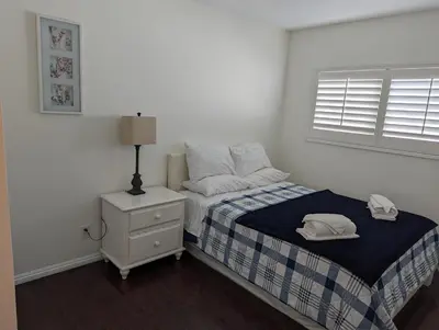 a bedroom with a bed with a nightstand and a window at 2Bedroom with Den and 2BA 4 Blocks to Santa Monica Beach in Los Angeles