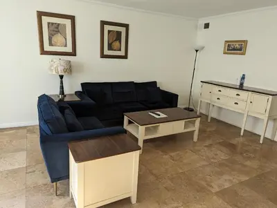 a living room with a blue couch and a table at 2Bedroom with Den and 2BA 4 Blocks to Santa Monica Beach in Los Angeles