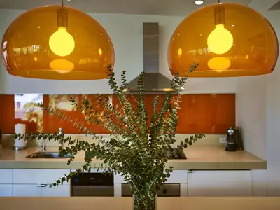 a kitchen with two lights and a vase with a plant at Palms Place in Los Angeles