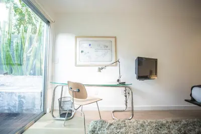 a desk with a chair in a room with a window at Venice Place in Los Angeles