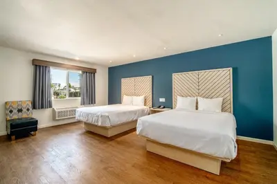 two beds in a room with blue walls at Trend Hotel at LAX Airport in Inglewood