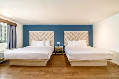 two beds in a room with blue walls at Trend Hotel at LAX Airport in Inglewood