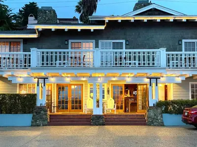 a house with a balcony on the front of it at Inn On SummerHill in Summerland