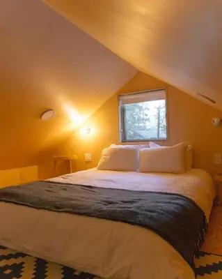 a bedroom with a large bed with a window at Colorado Lodge in Big Bear Lake