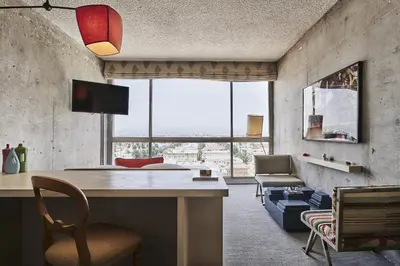 a living room with a desk and a chair at The LINE Hotel LA in Los Angeles