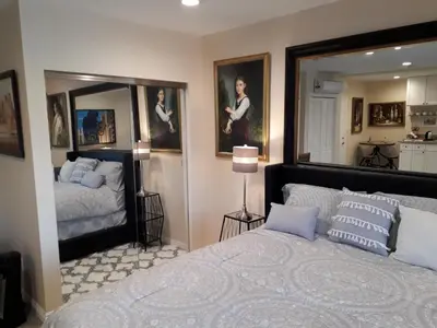 a bedroom with a bed and a large mirror at Comfortable Luxury Studio in Los Angeles
