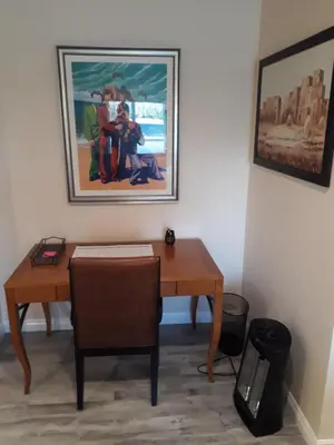 a room with a desk and a painting on the wall at Comfortable Luxury Studio in Los Angeles