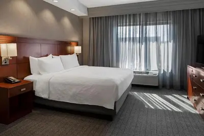 a hotel room with a large bed and a window at Courtyard Long Beach Airport in Long Beach