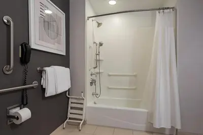 a bathroom with a shower and a white shower curtain at Courtyard Long Beach Airport in Long Beach