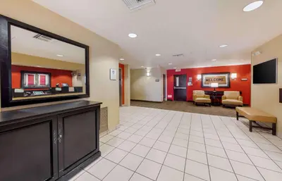 a hotel lobby with a large flat screen tv at Extended Stay America Suites - Orange County - Huntington Beach in Huntington Beach