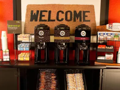 a store with a welcome sign on a counter at Extended Stay America Suites - Orange County - Huntington Beach in Huntington Beach