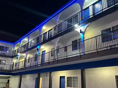 a building with a balcony with blue lights on it at Cloud 9 Inn LAX in Inglewood