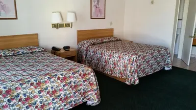 a hotel room with two beds in a room at Economy Inn Motel in Sylmar