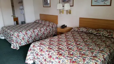 a hotel room with two beds and a telephone at Economy Inn Motel in Sylmar