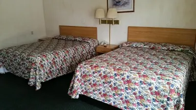 a hotel room with two beds in a room at Economy Inn Motel in Sylmar