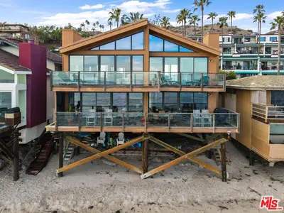 a large house on the beach with glass at Villa Rylee in Malibu