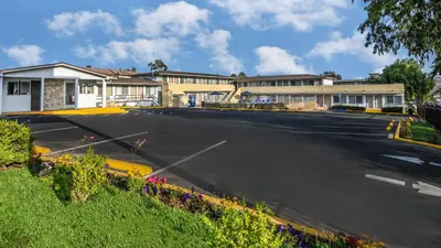 an empty parking lot in front of a building at Sea Rock Inn - Long Beach in Long Beach