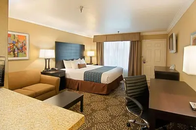 a hotel room with a bed and a desk at Hotel d'Lins Ontario Airport in Ontario