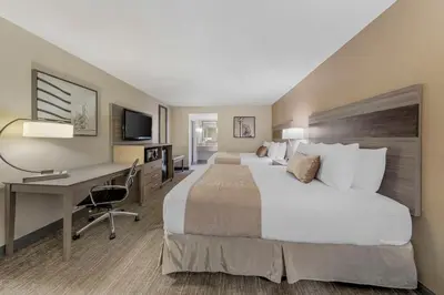 a hotel room with a large bed and a desk at Best Western Plus Executive Inn Rowland Height City of Industry in Rowland Heights