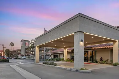 a building in a parking lot next to a street at Best Western Plus Executive Inn Rowland Height City of Industry in Rowland Heights