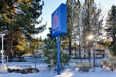 a sign for a hotel in the snow at Motel 6-Big Bear Lake, CA in Big Bear Lake