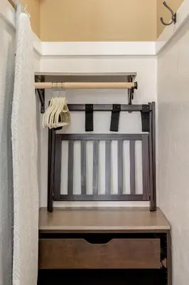 a bed in a room with a curtain and a bed frame at Casita Gundry- Boutique Hideaway, Quaint Historic Charm in Long Beach