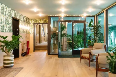 an office with a lobby with glass doors and plants at Palihotel Hollywood near Universal Studios in Los Angeles