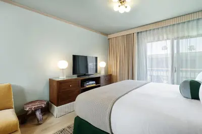a hotel room with a bed and a television at Palihotel Hollywood near Universal Studios in Los Angeles