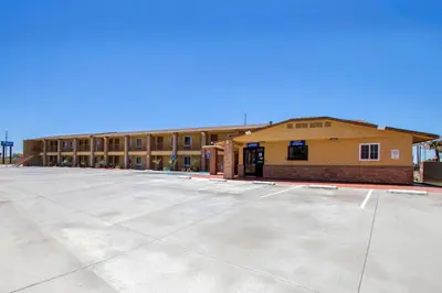 an empty parking lot in front of a building at Rodeway Inn Adelanto US 395 in Adelanto