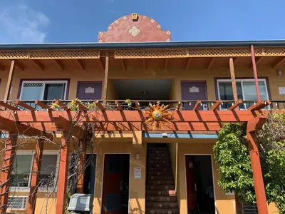a house with a deck and stairs on it at Sandyland Reef Inn in Carpinteria