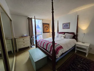 a bedroom with a four poster bed and a window at Ocean Front Vortex Female Hostel private rooms Free bikes in Los Angeles