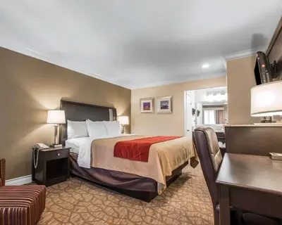 a hotel room with a bed and a desk at Quality Inn Downey in Downey
