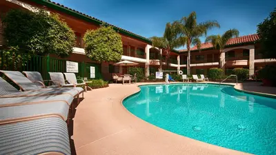 a swimming pool in front of a hotel at Best Western San Dimas Hotel & Suites in San Dimas
